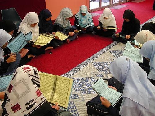 a group of little girls recite the Qur'an.