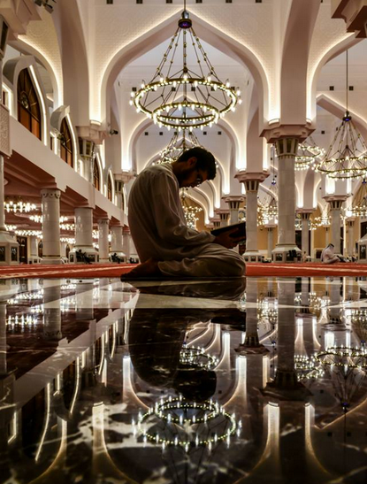 a Muslim recites the Qur'an while being in the mosque - people of Allah