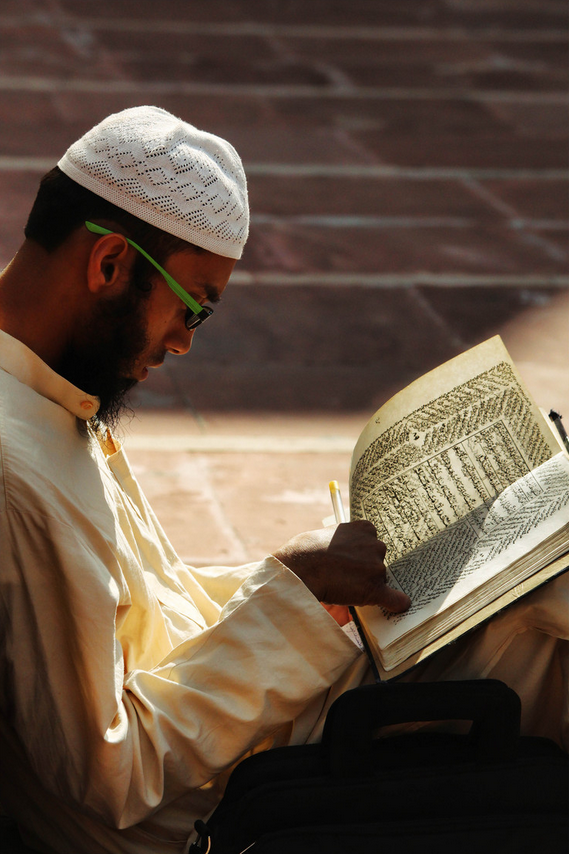 A man recites the Qur'an - The Qur’an Elevates Some and Degrades Others